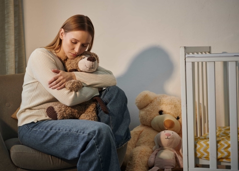 Frau im Kinderzimmer ohne ein Kind